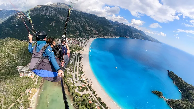 A tandem paraglider above the Oludeniz lagoon
